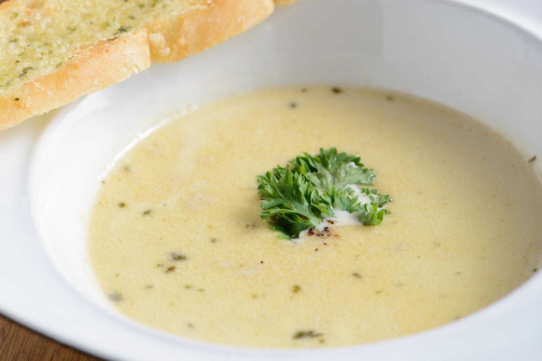 A bowl of puree of white bean and celery root soup.