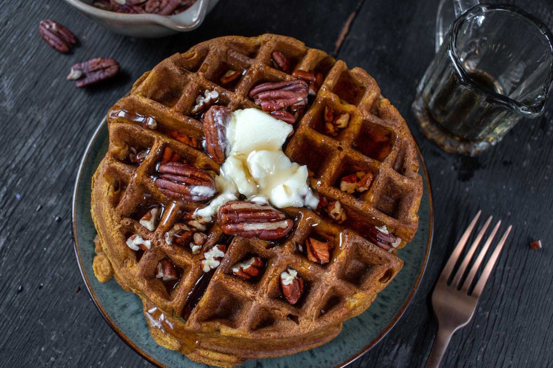 Overhead view of waffle with pecans on top.