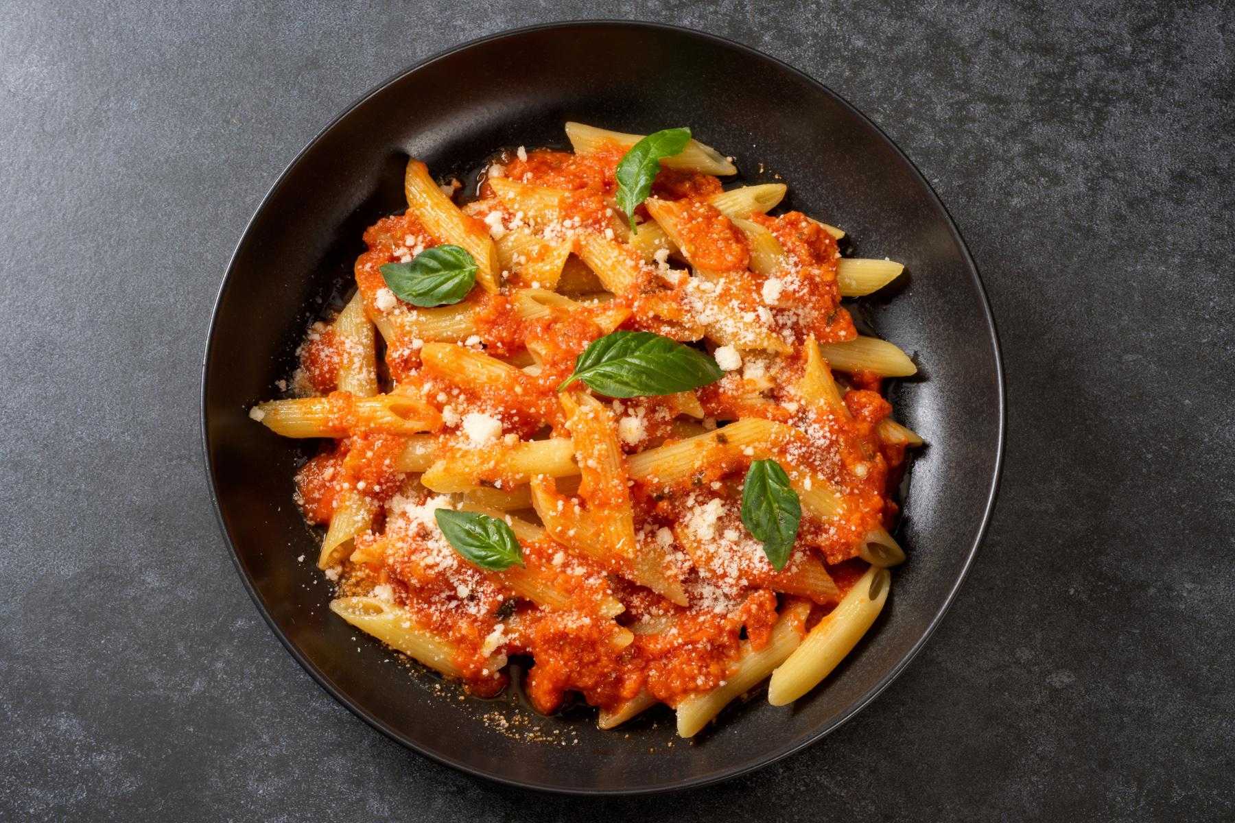 Overhead view of a bowl of pasta with crab and cream sauce.