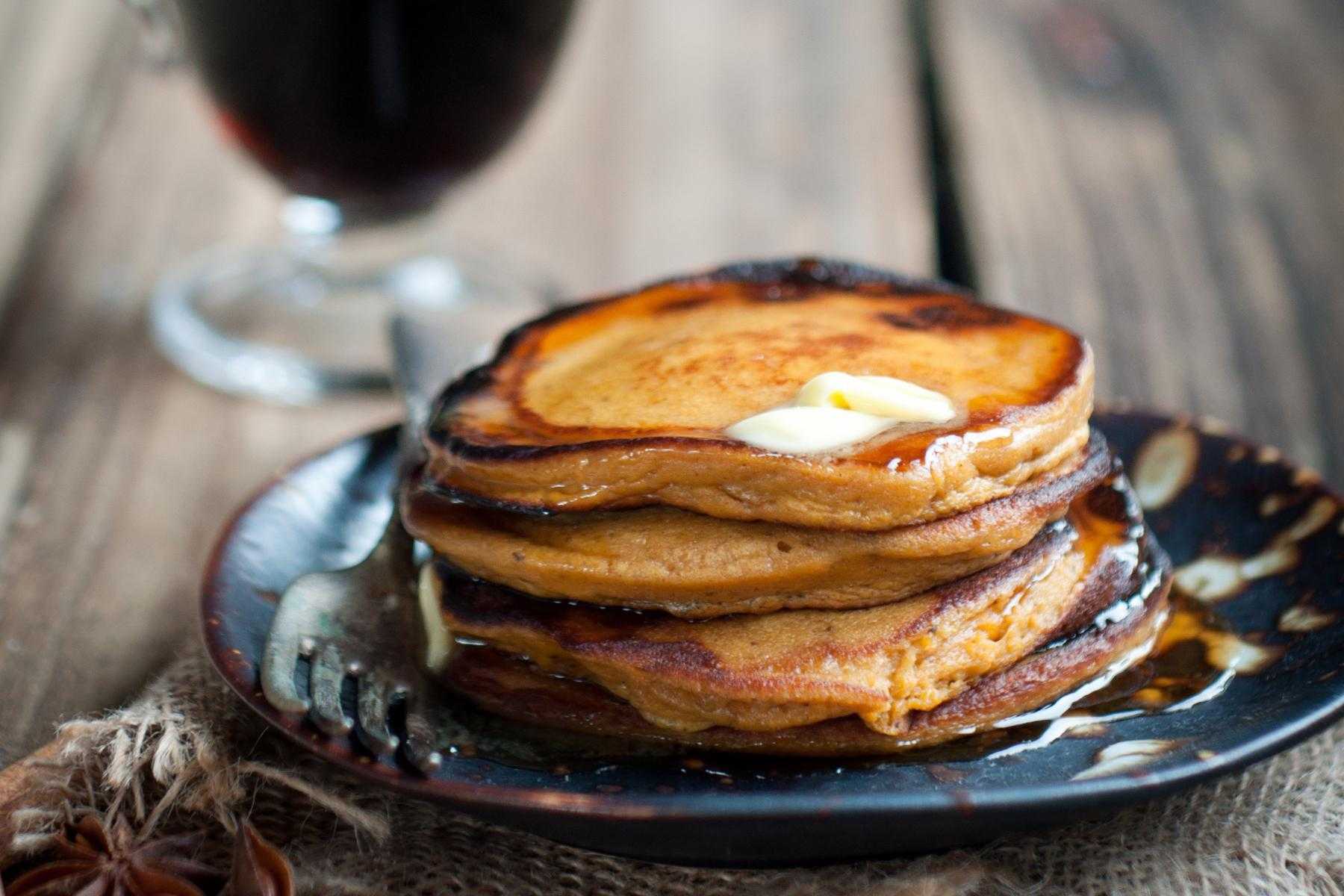 Stack of sweet potato pancakes on plate.