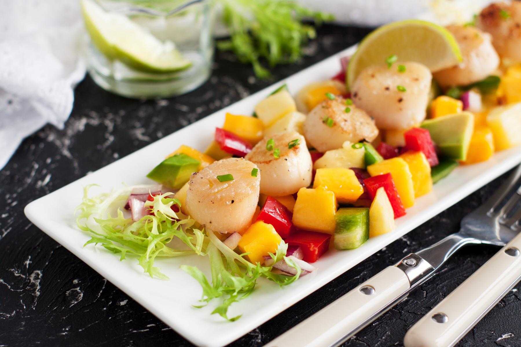 Plate of scallops on mango salsa.