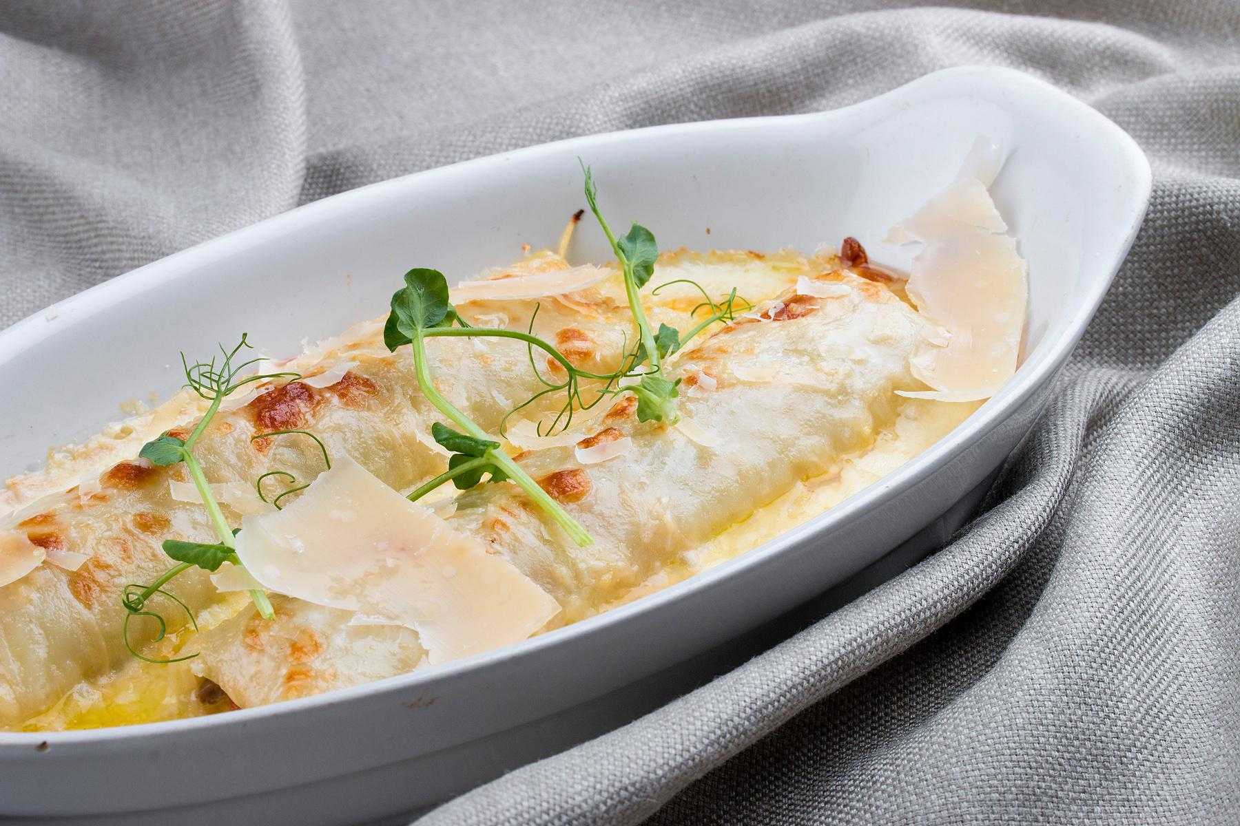 A pan of roasted vegetable manicotti.