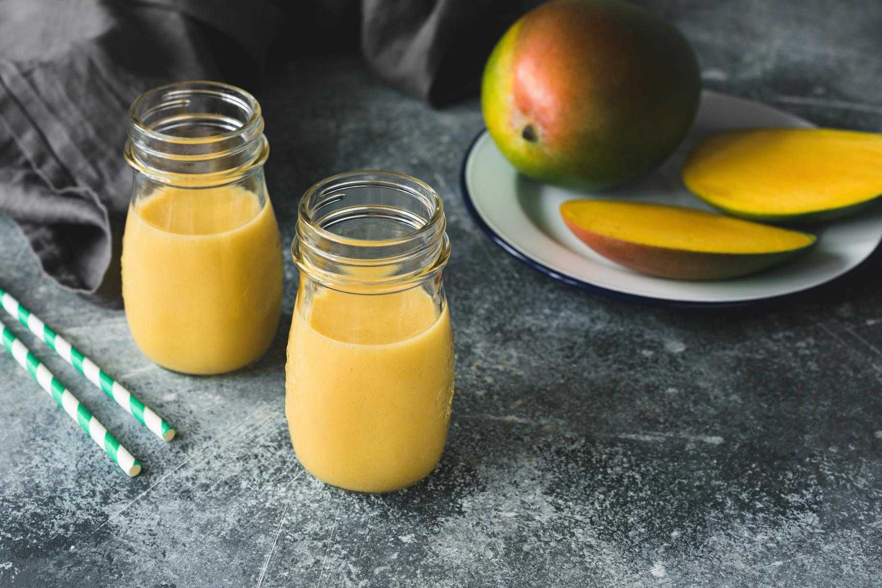 Close-up of tropical orange smoothies in class jars.