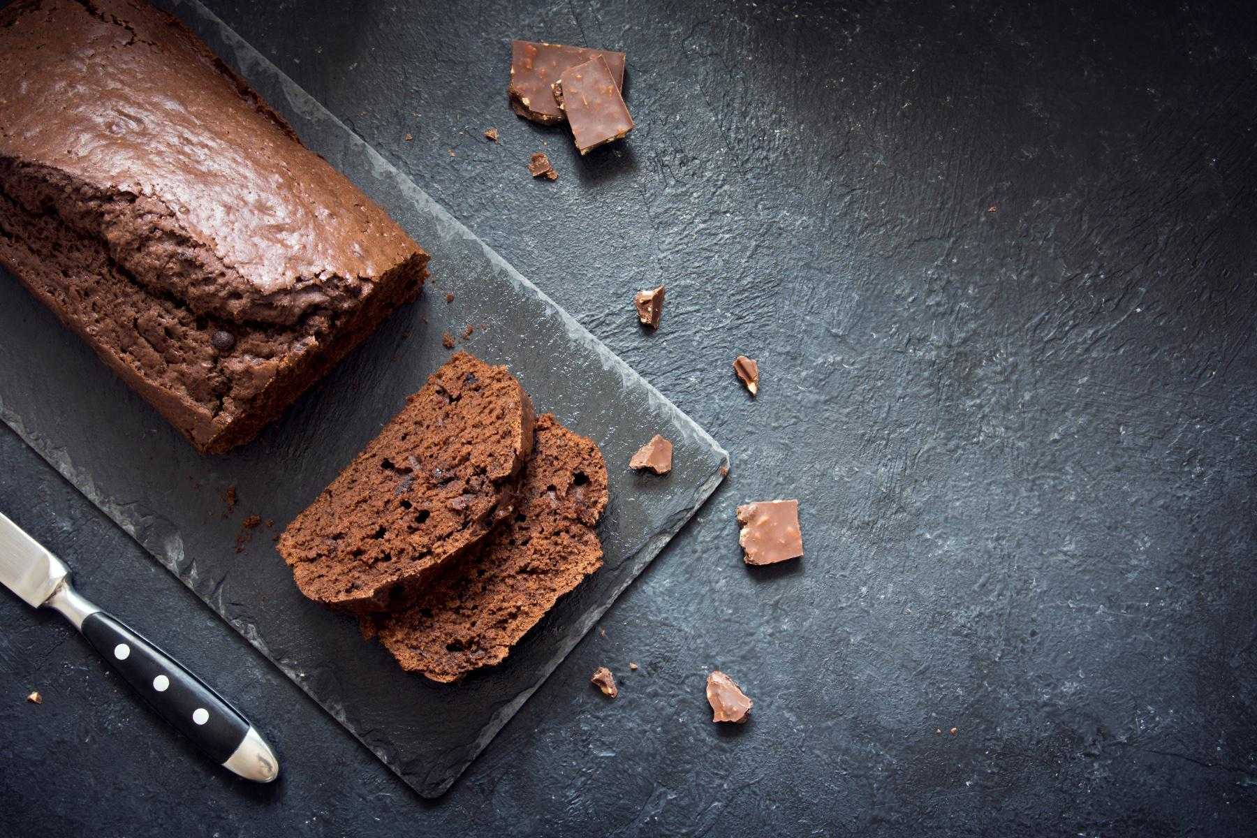Overhead view of mocha pound cake in slices on slate board.