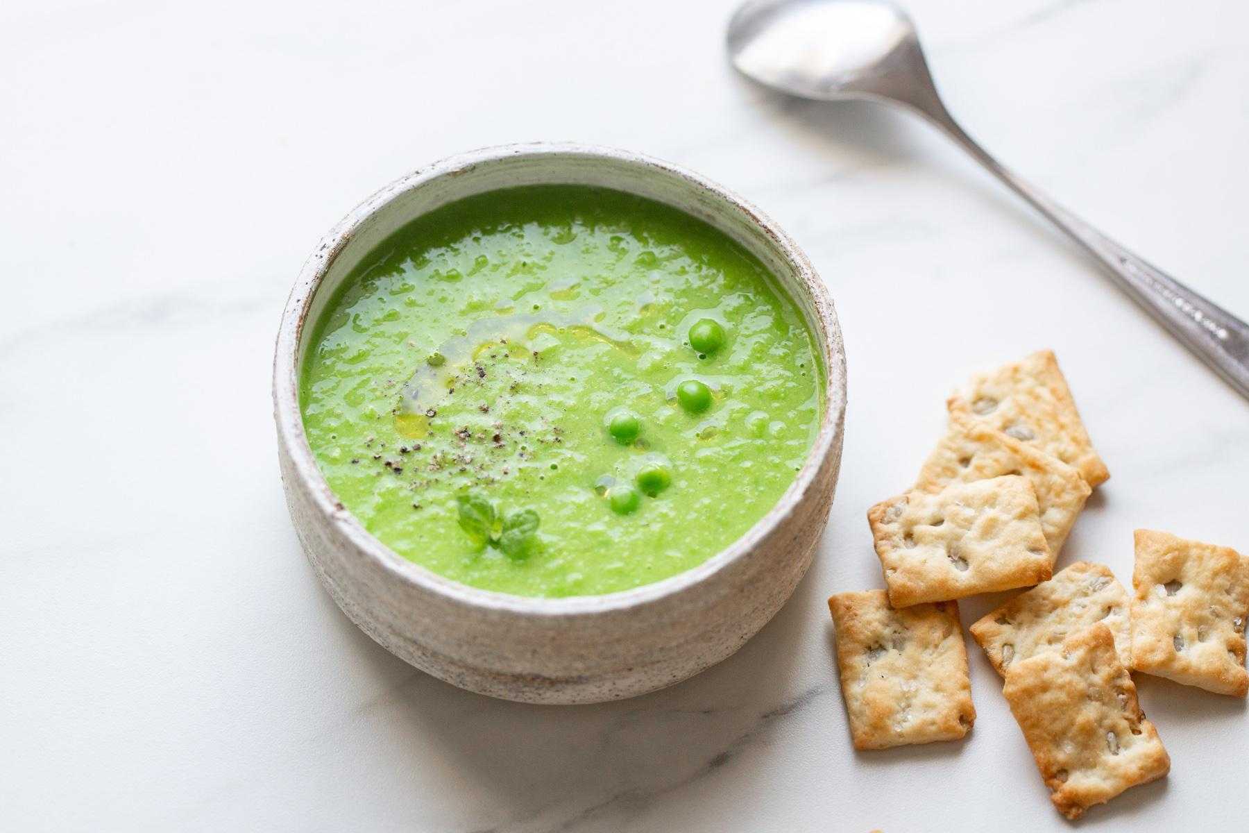 Overhead view of a bowl of spring pea soup.