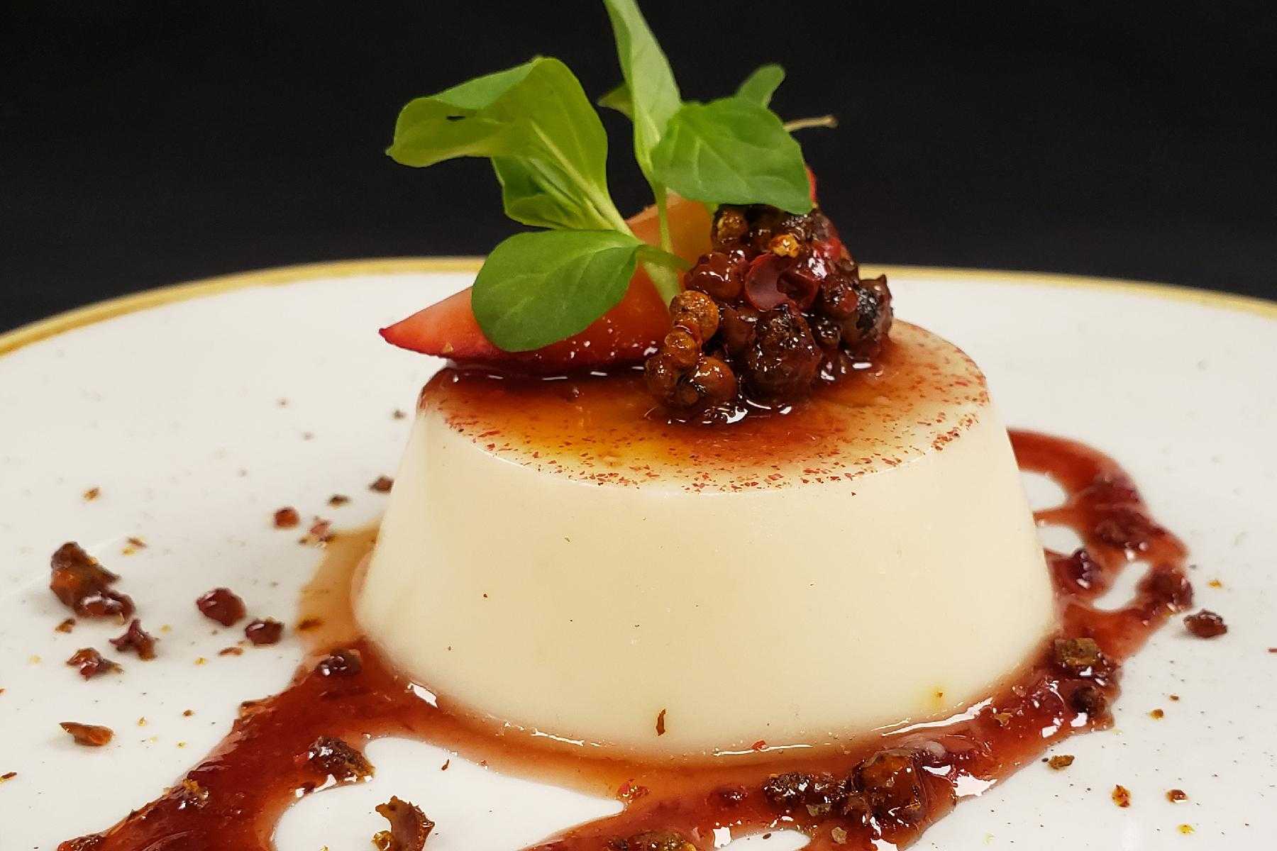 Close-up image of Pink Peppercorn Panna Cotta on a plate.