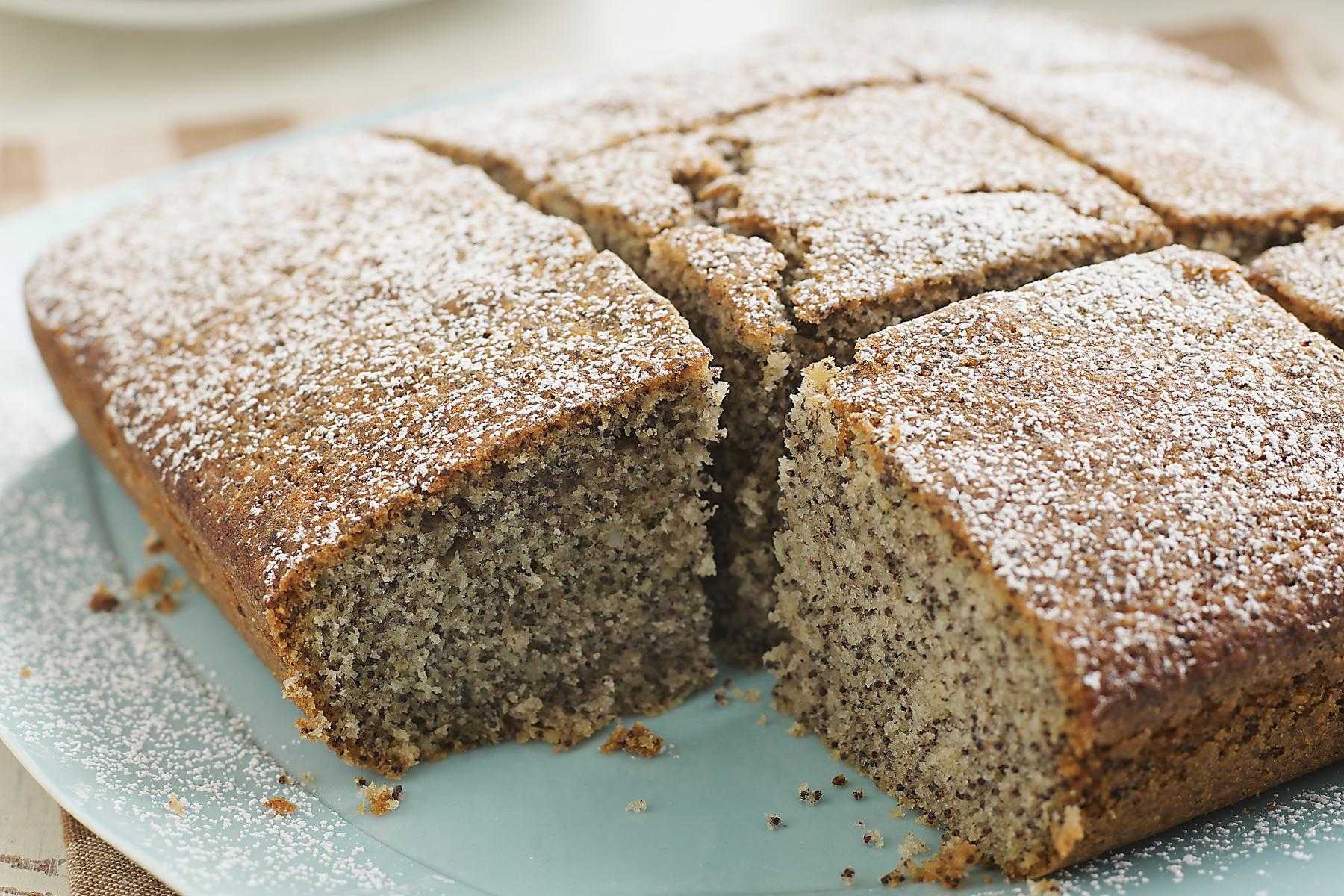 A plate of poppyseed cake with lemon glaze.