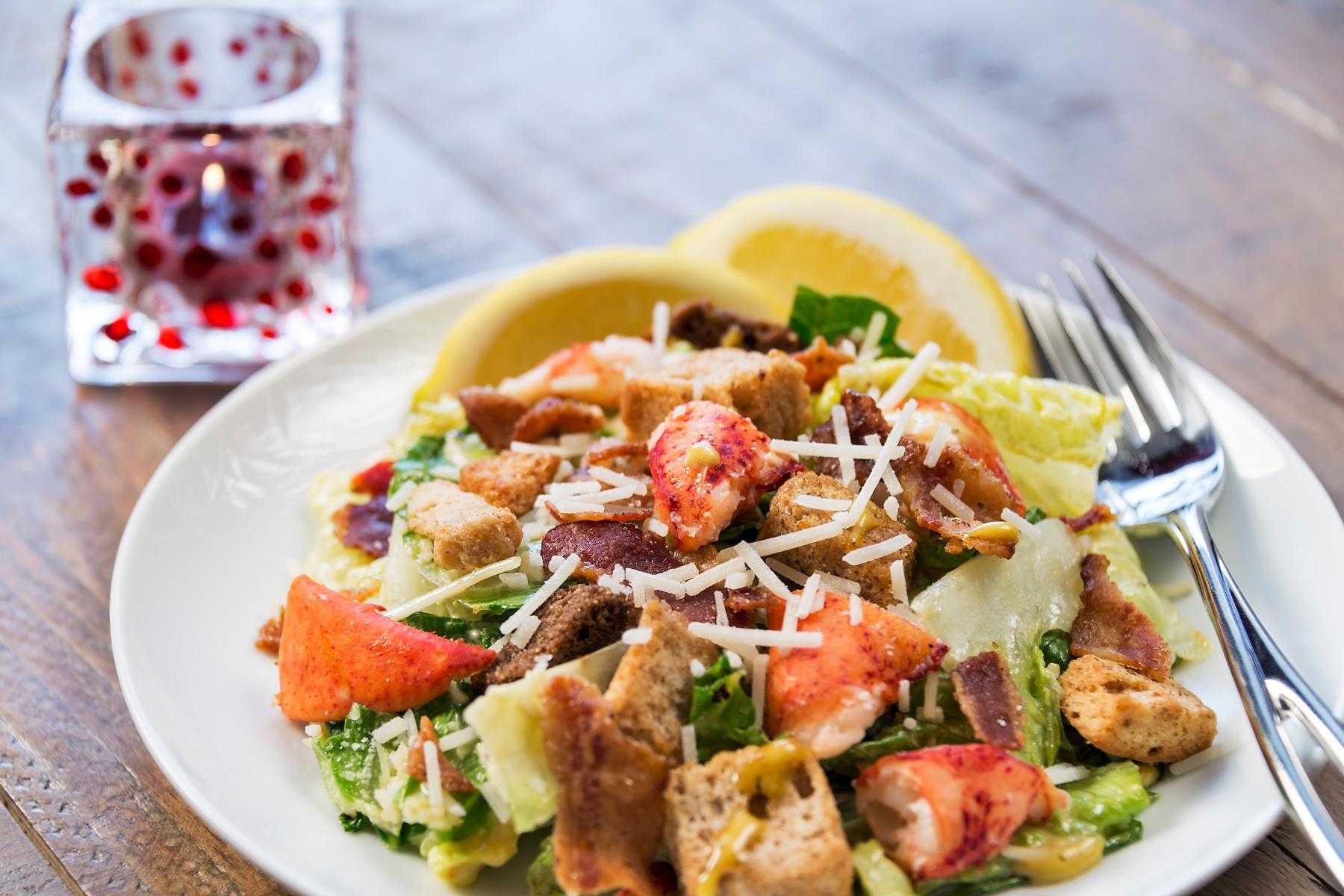 Close-up of a plate of lobster Caesar salad.