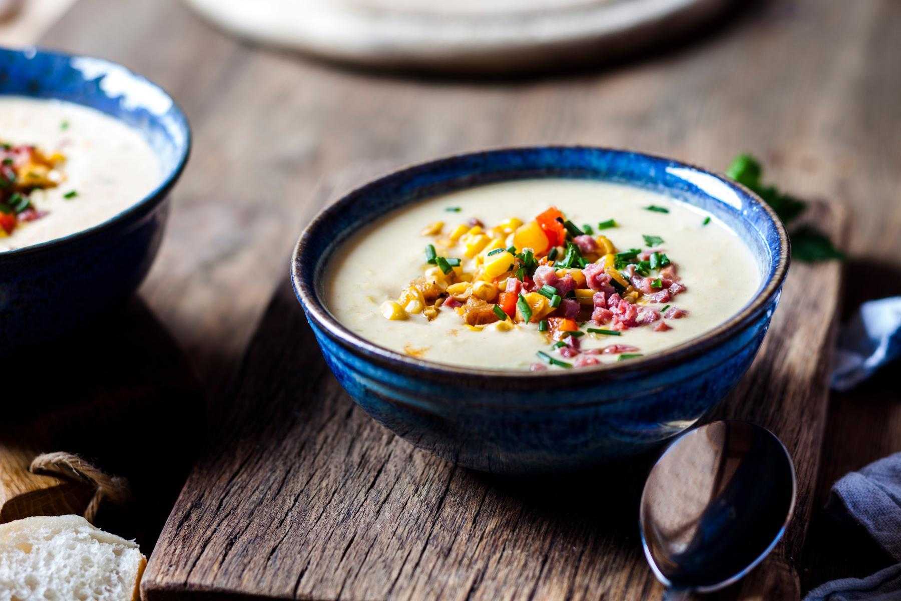 A blue bowl of roasted corn chowder.