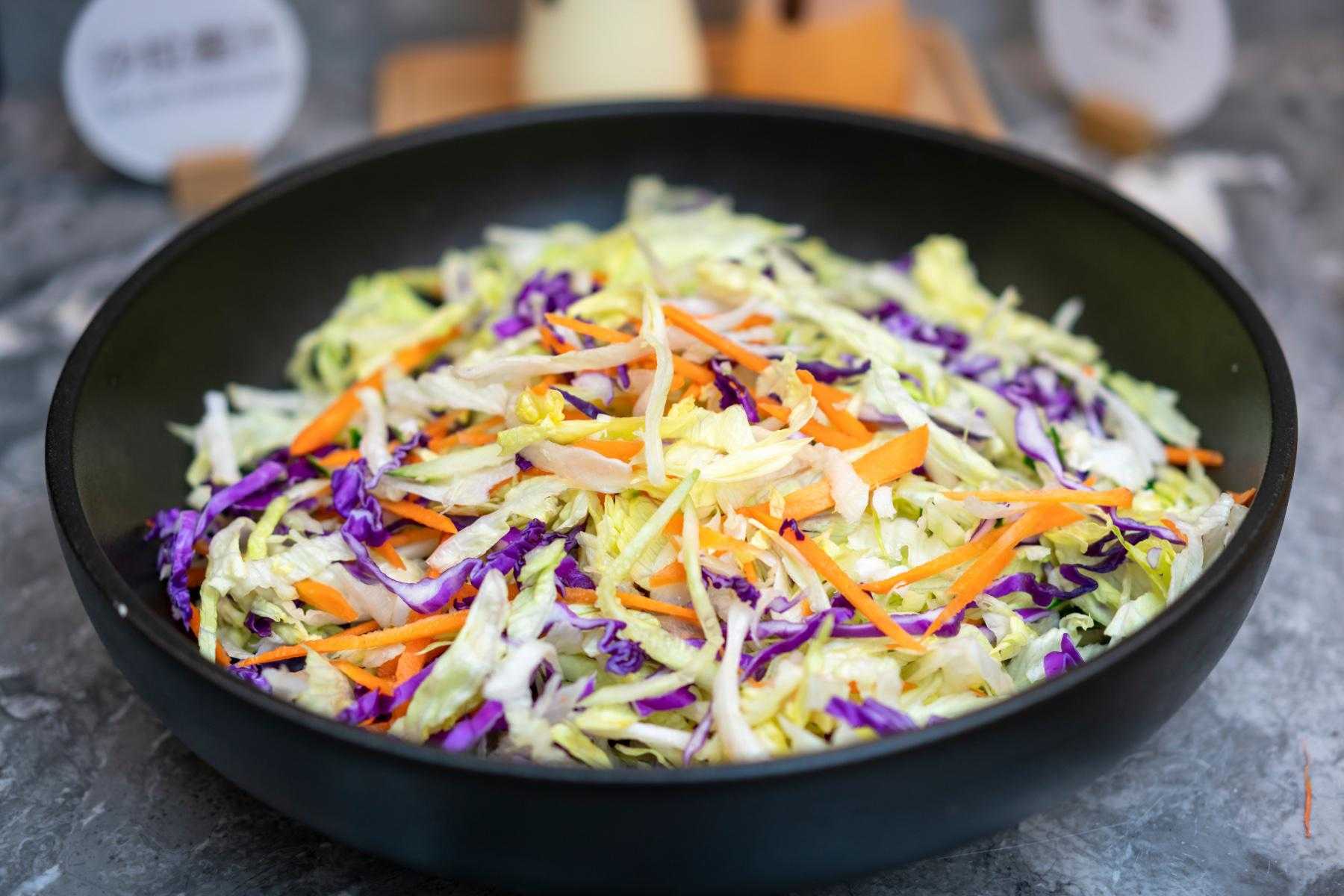 Black bowl filled with jicama slaw.