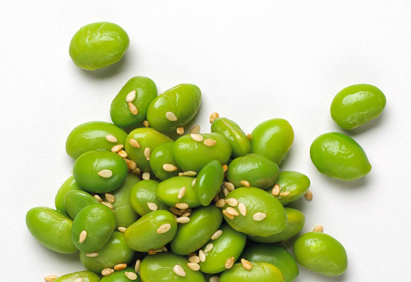 Close-up of soybeans with sesame seeds on them.