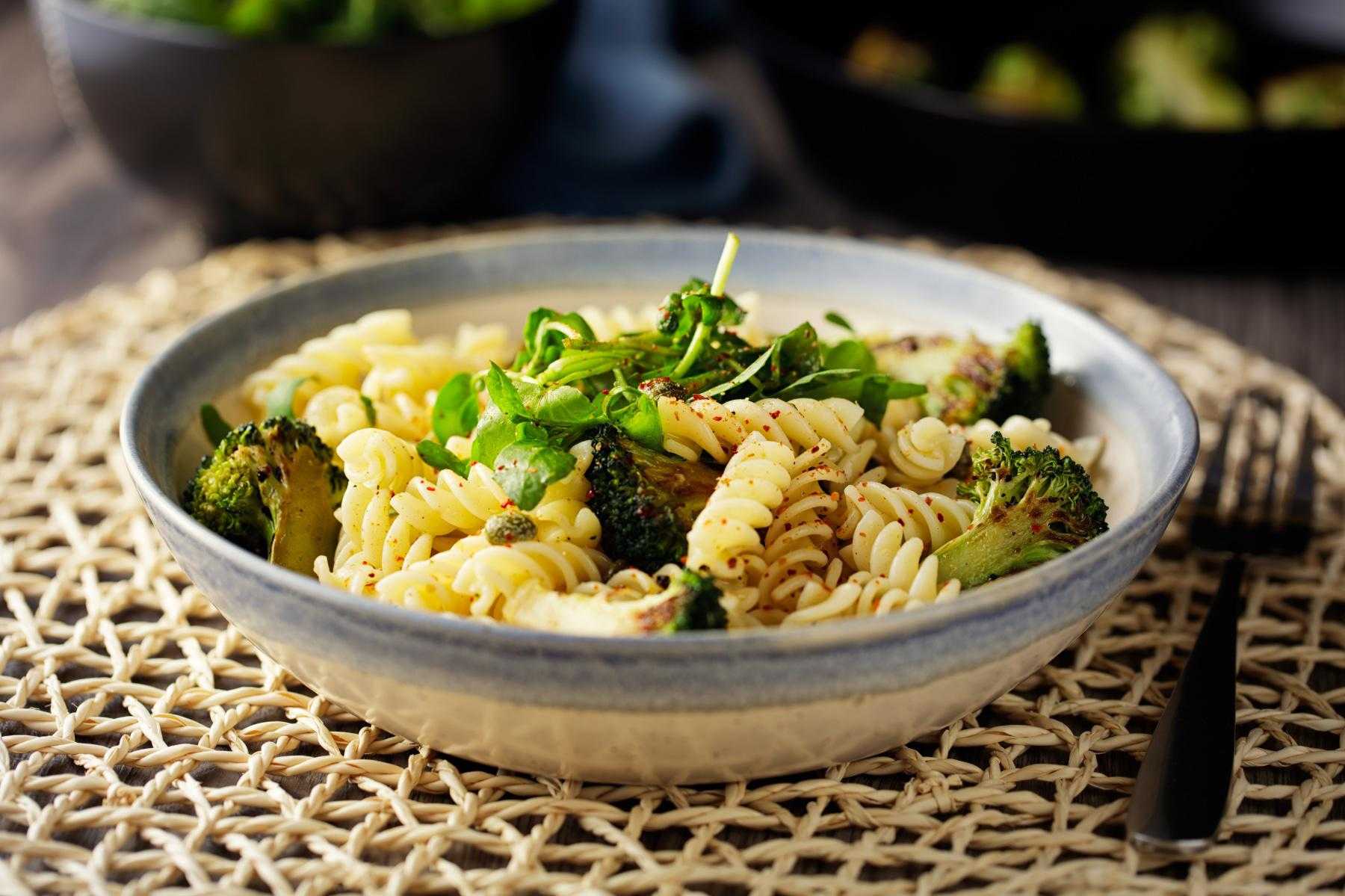 Bowl of pasta salad on placemat.