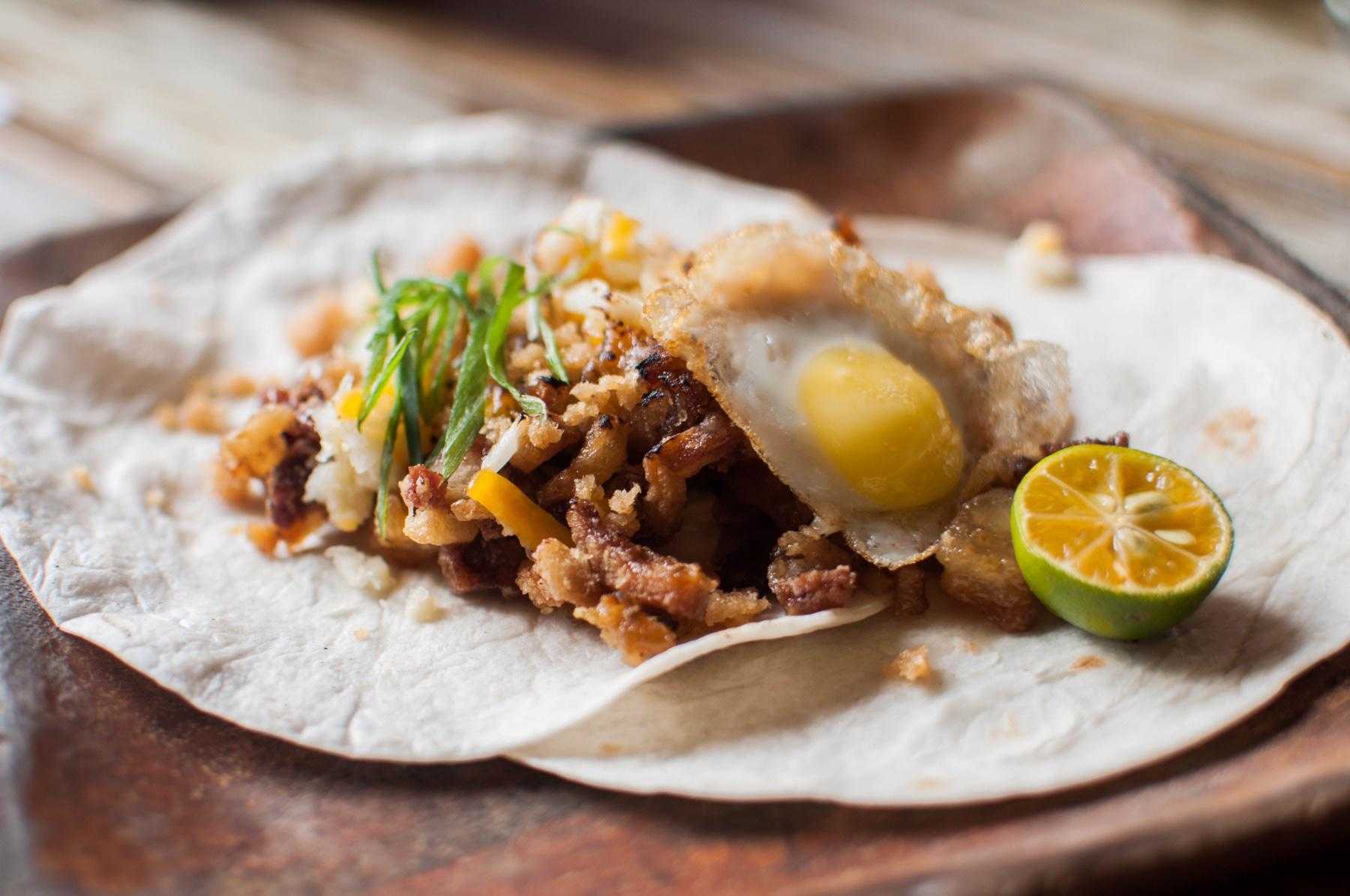 Southwest turkey on open tortilla with egg on top.