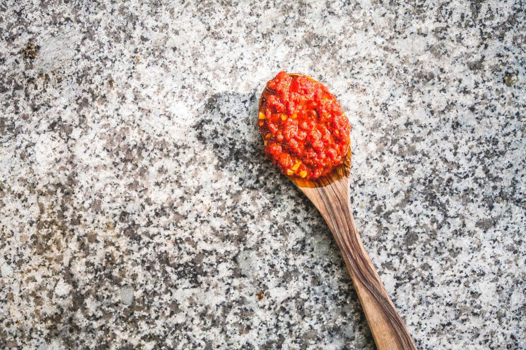 Spoonful of sweet red pepper sauce.