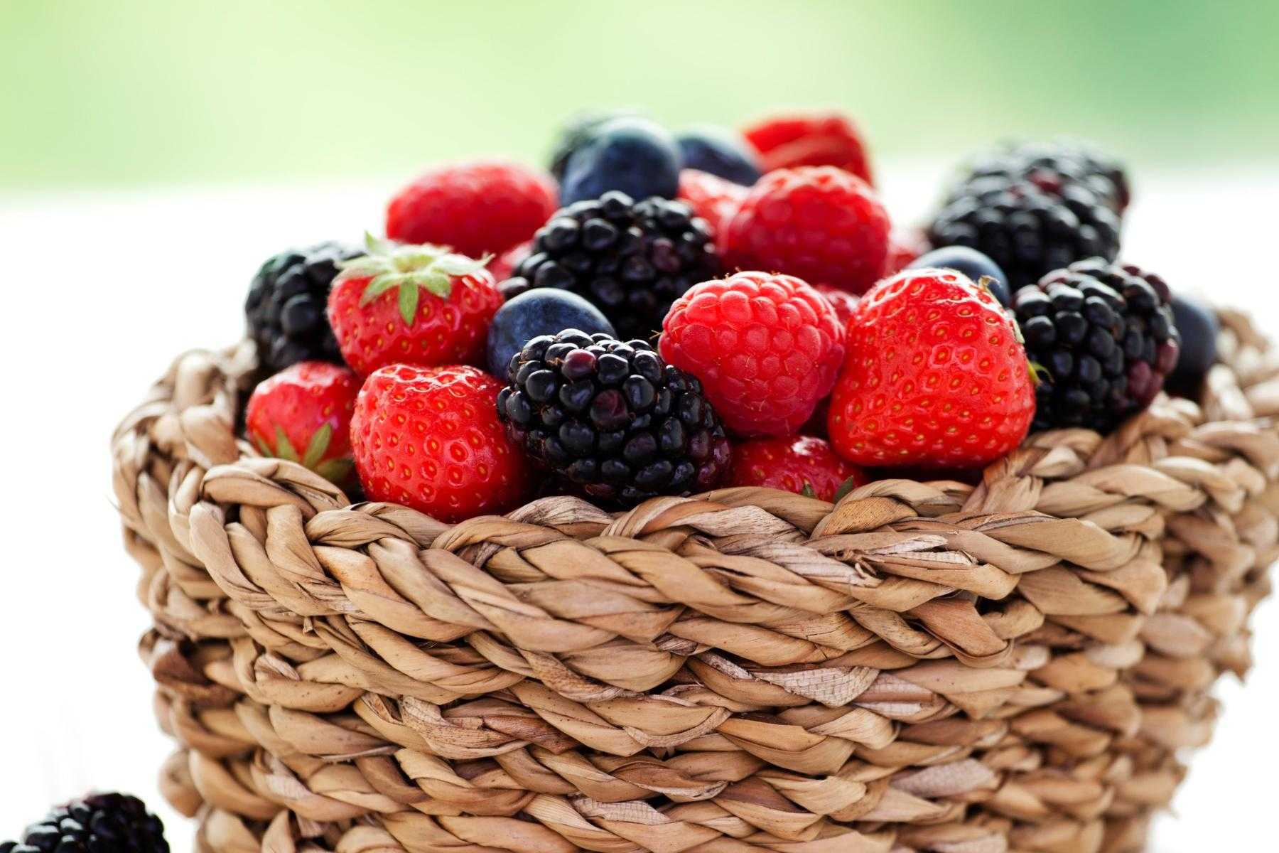 Close-up of basket filled with raspberries and blackberries.