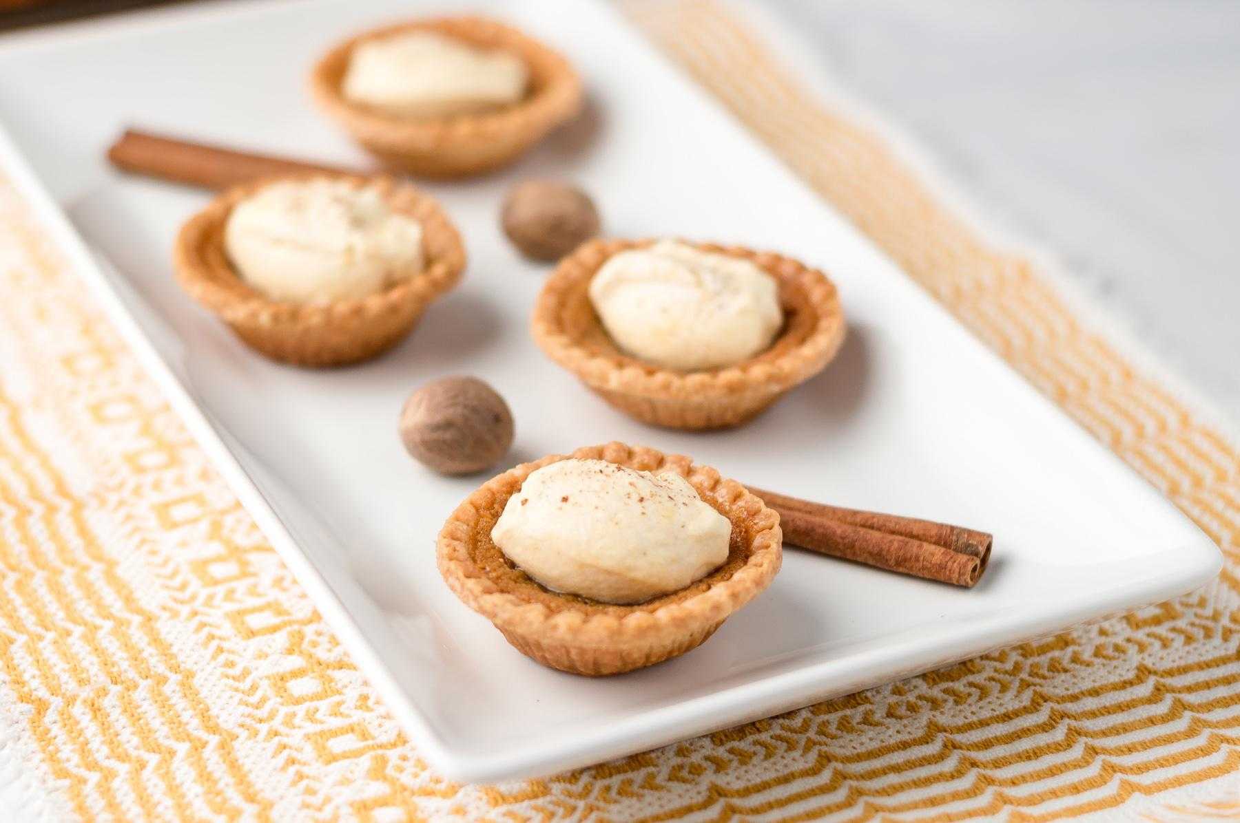 A rectangular plate of sweet potato tartlets with a blue corn pecan crust.