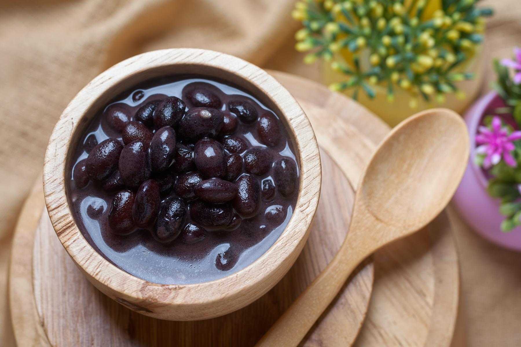 Black beans in a small wooden bowl.
