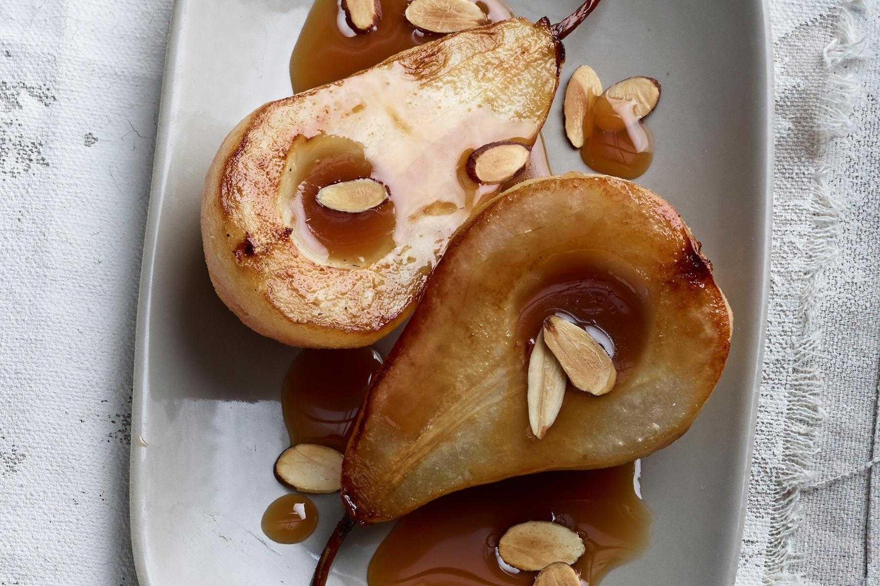 Overhead view of simmered pears cut in half.