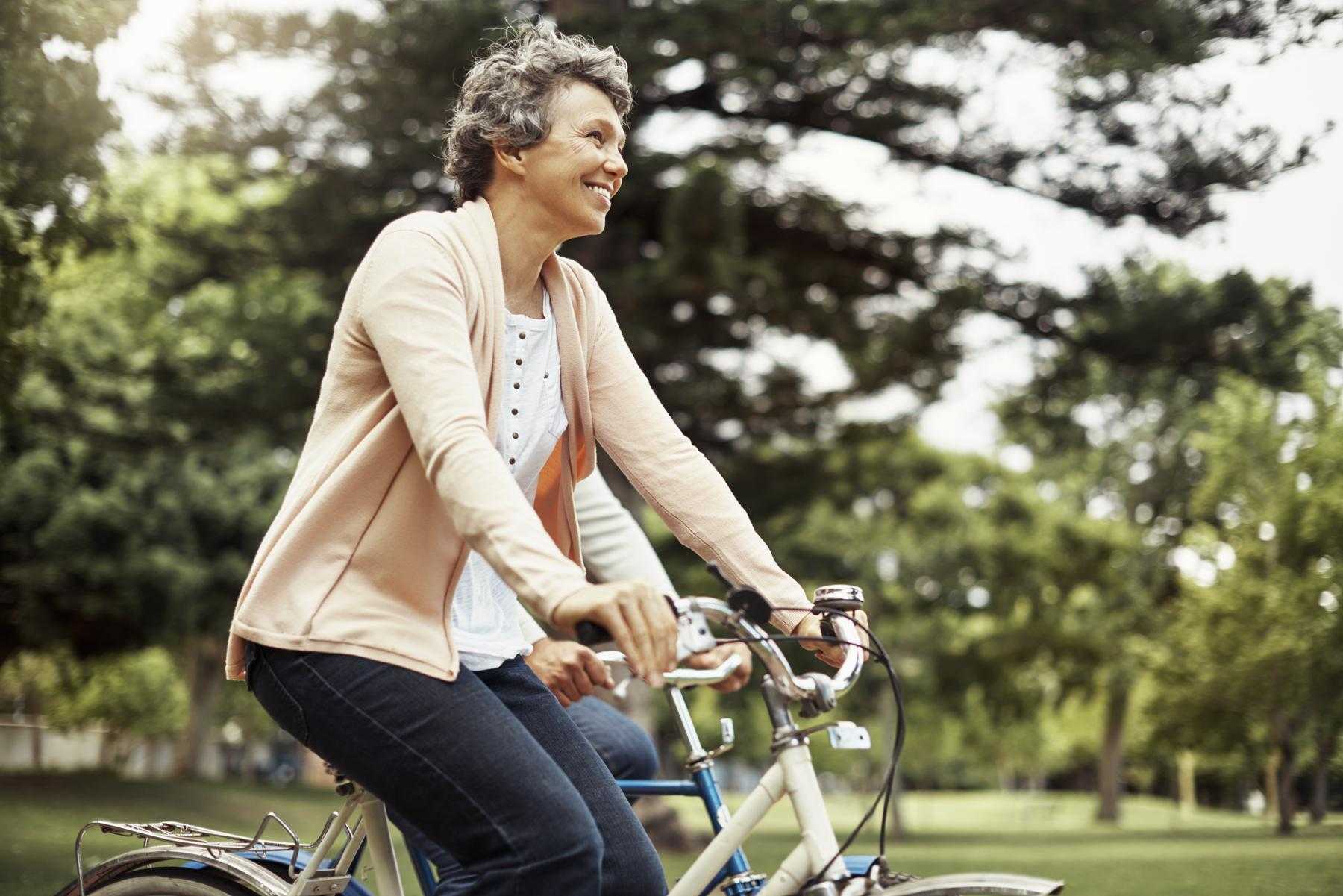 Woman riding a bicycle outside.