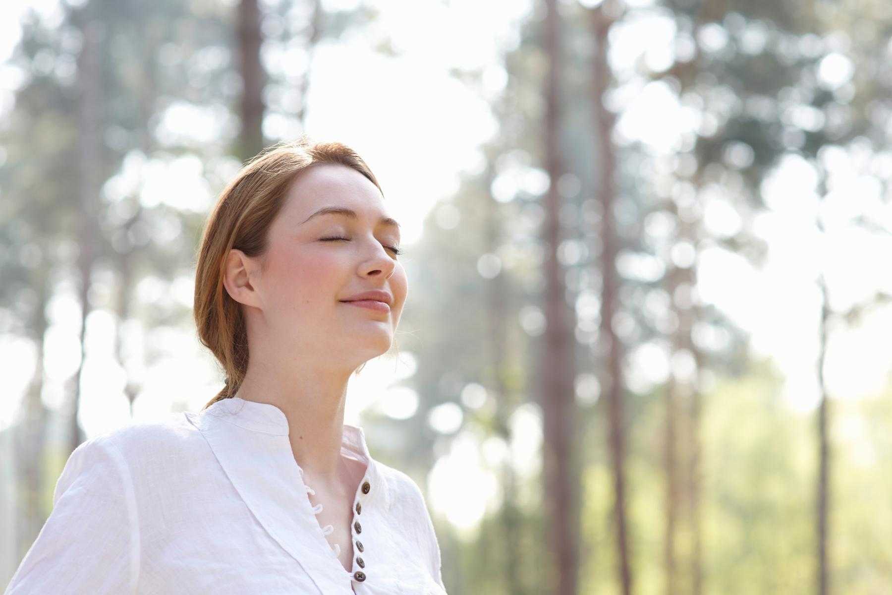 Close-up of man sitting on couch leaning back with eyes closed.