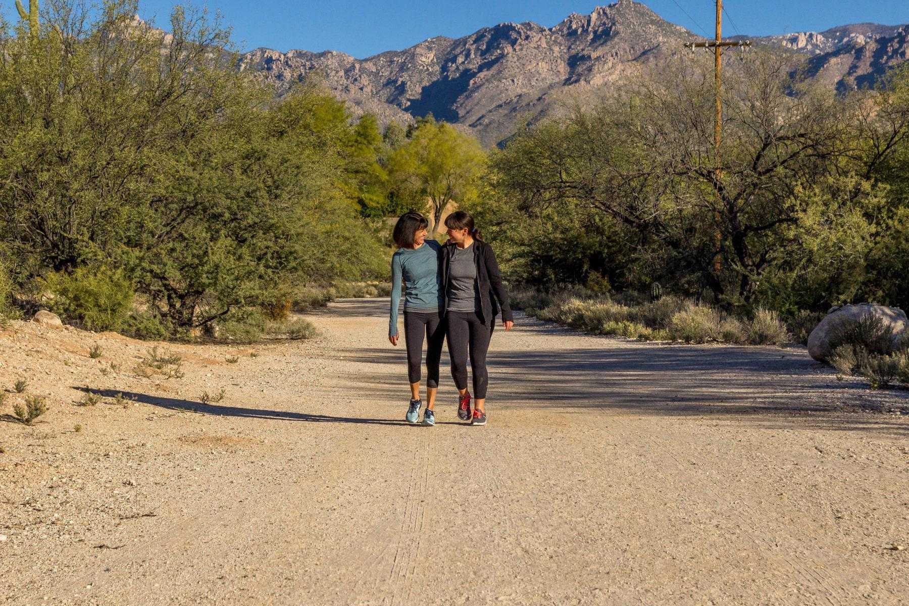 Two women walking a hiking trail at Canyon Ranch Tucson.
