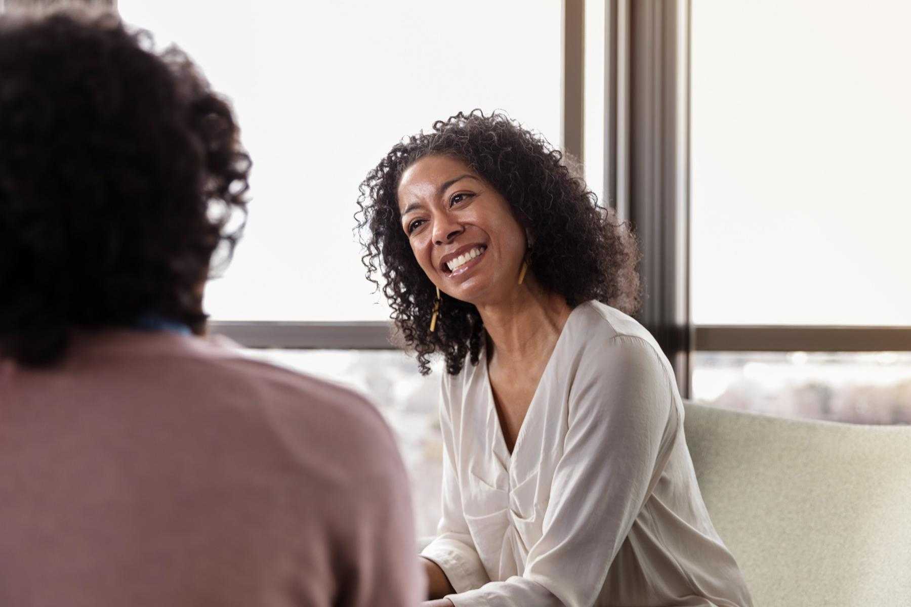 A spiritual counselor smiling at her client.