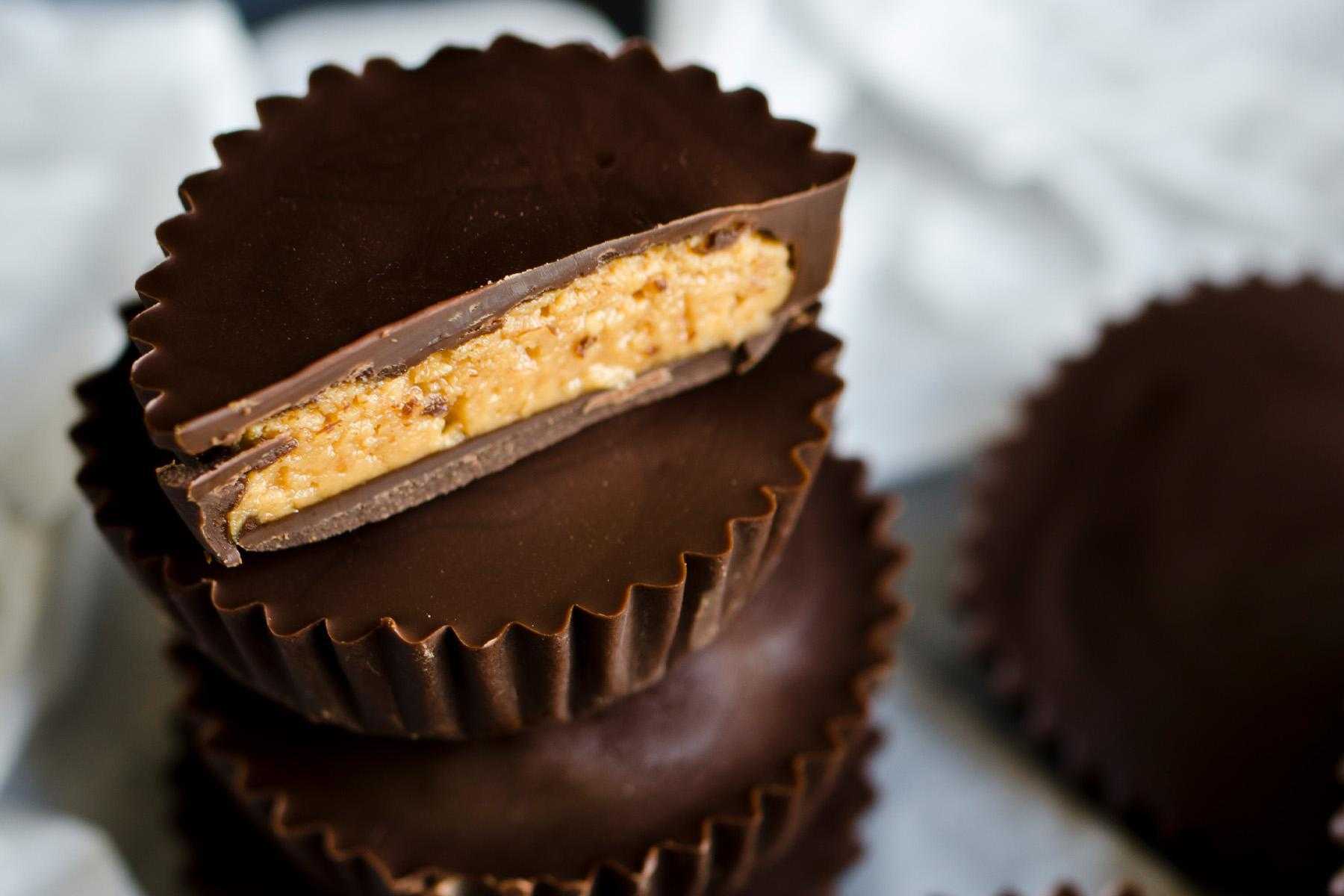 Close-up image of a dark chocolate peanut butter cup.