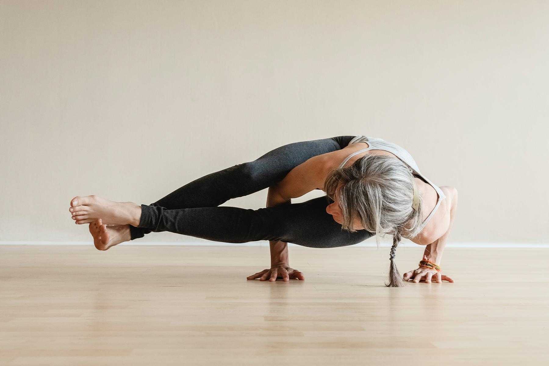 close-up of woman doing side plank in yoga studio