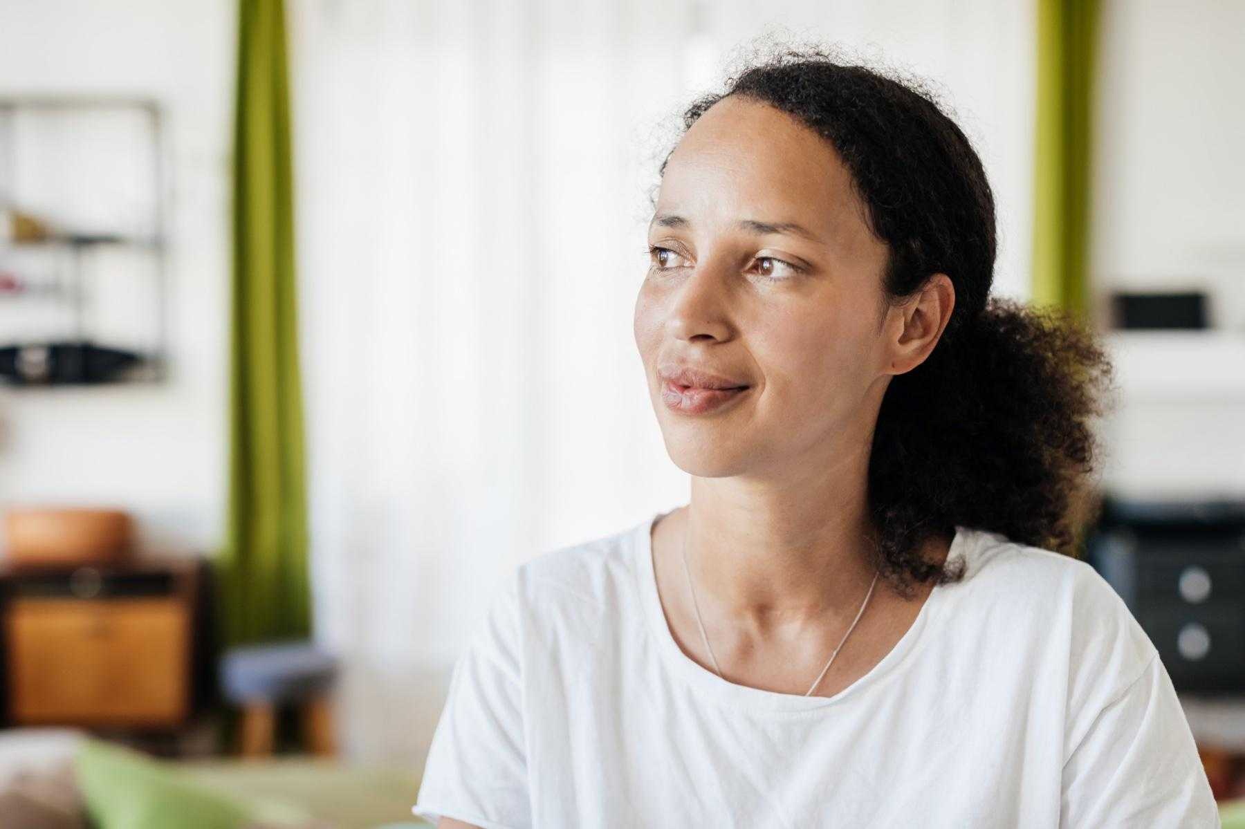 Woman looking off to the side with a slight smile.