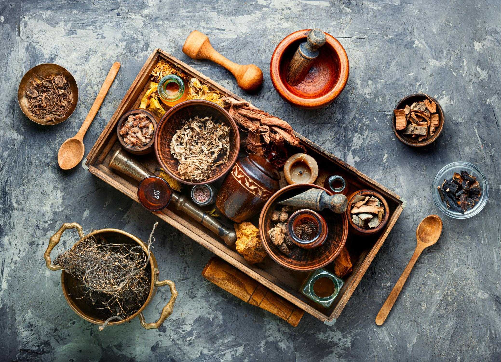 Overhead view of Chinese herbs on dark blue table.