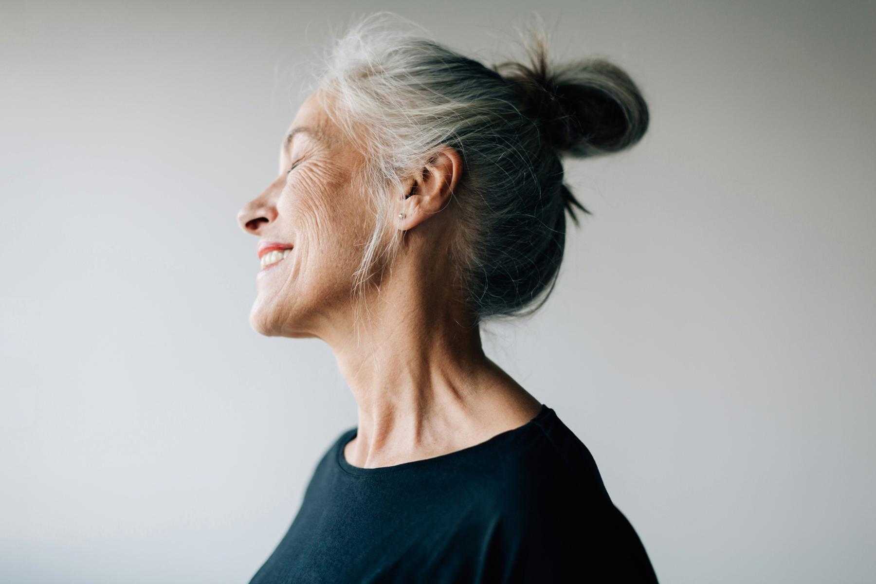 A mature woman smiling.