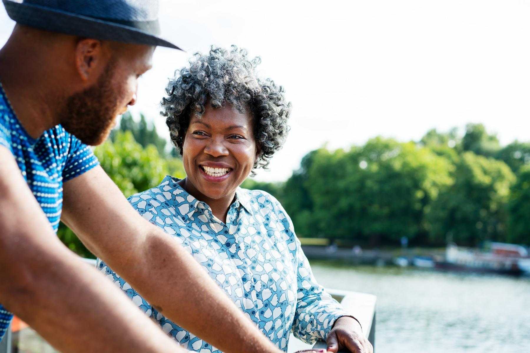 A husband and wife laughing together.