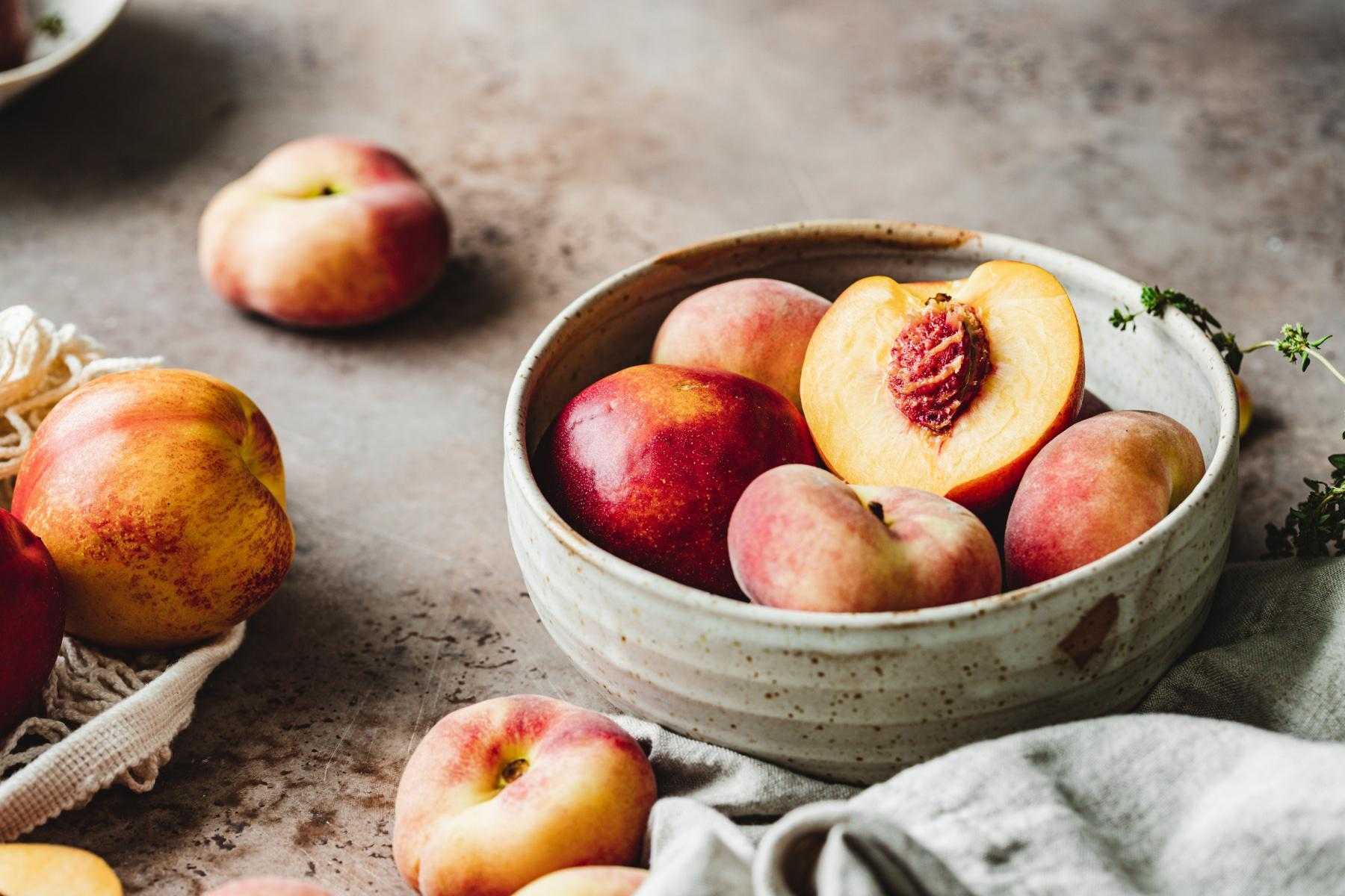 close-up of a bowl of fresh peaches
