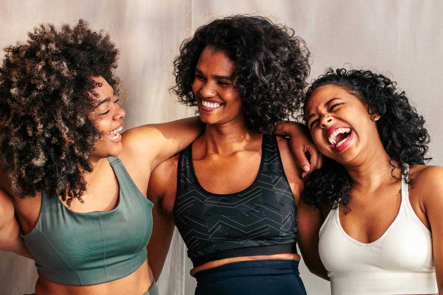 a group of three women laughing