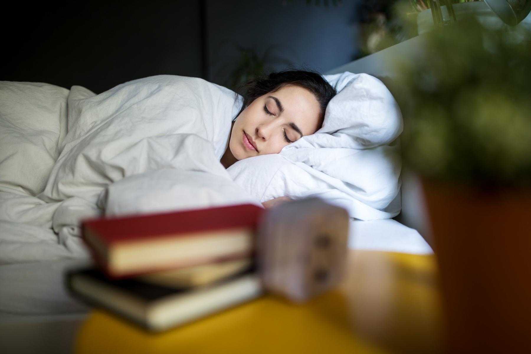 Close-up of woman's face as she lays in bed on her side.