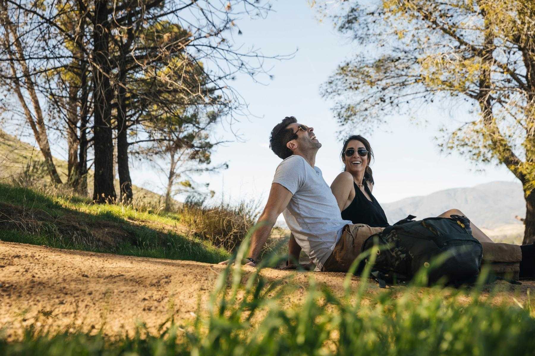 Couple sitting outside and laughing.