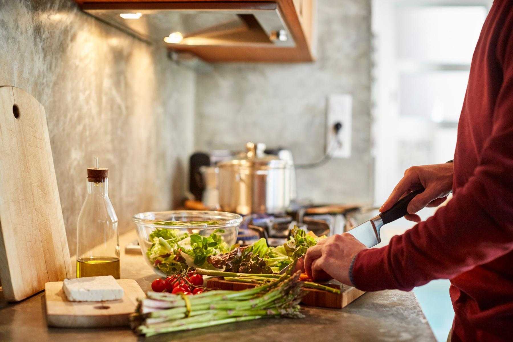 sideview of a man chopping vegetables