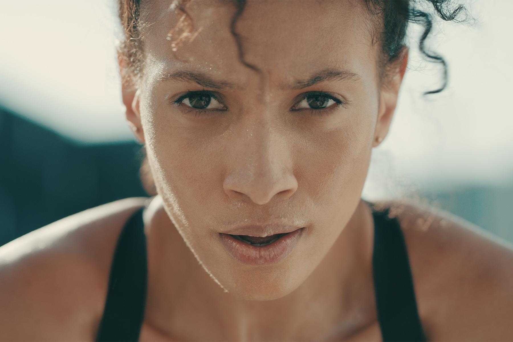 Close-up of woman's face during workout.