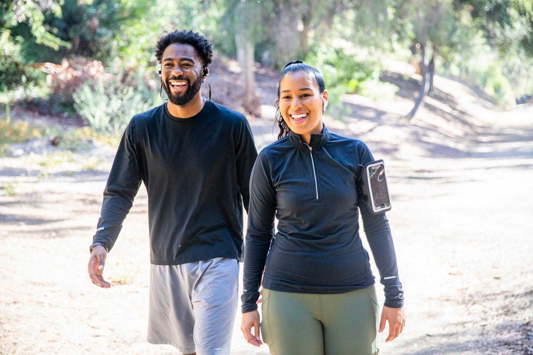 young, smiling, couple in workout clothes walking together on a path in Tucson, Arizona