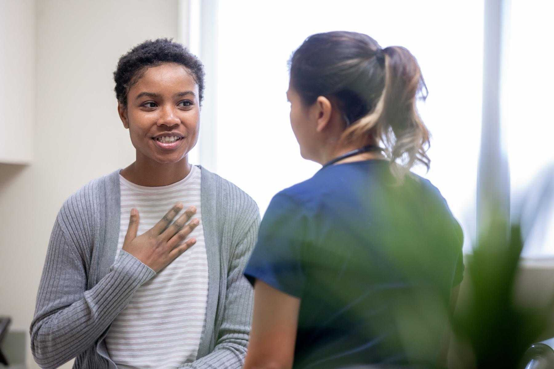 Woman talking to doctor.