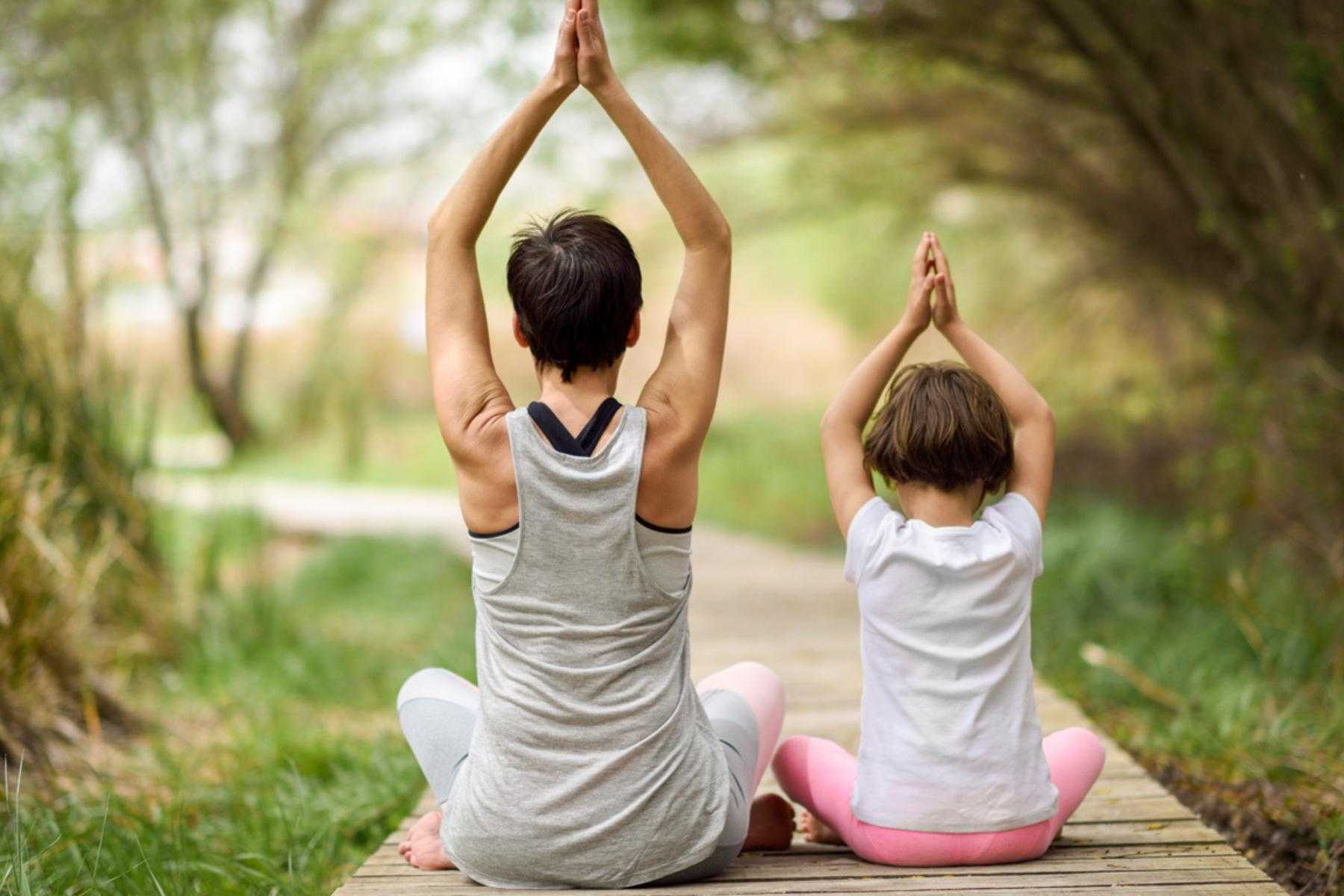 Woman and child doing yoga