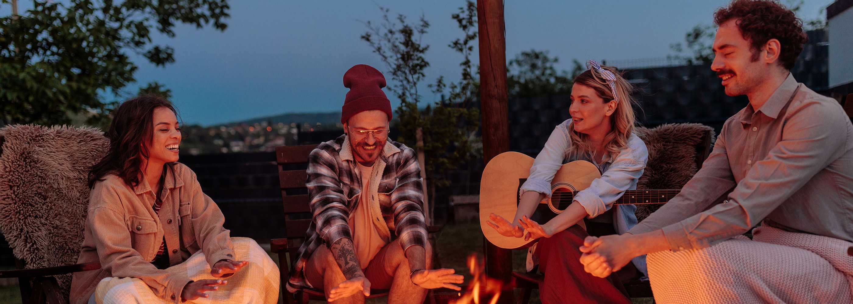 A group of adults in the woods at summer camp
