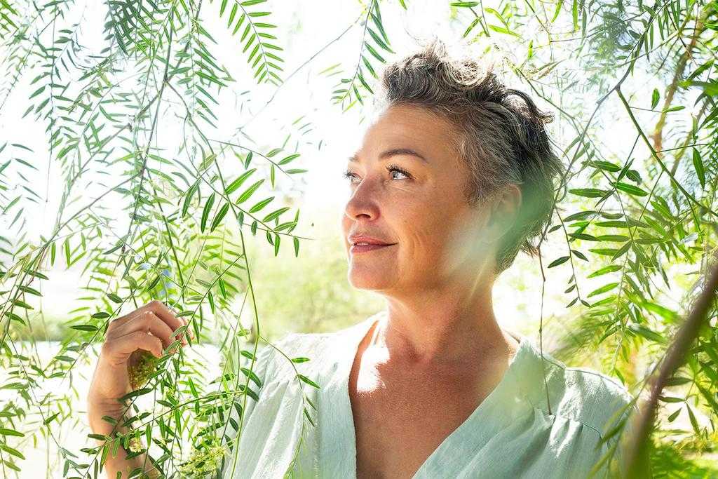 A woman in the forest in the summer sun