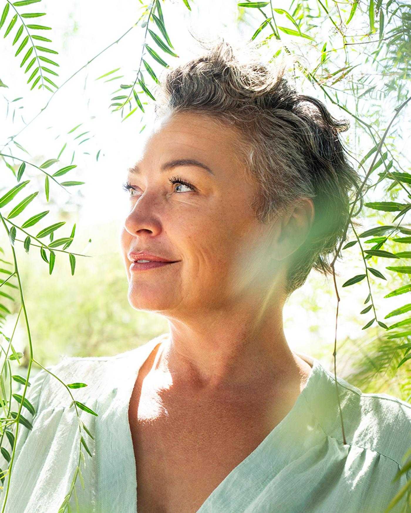 A woman in the forest in the summer sun