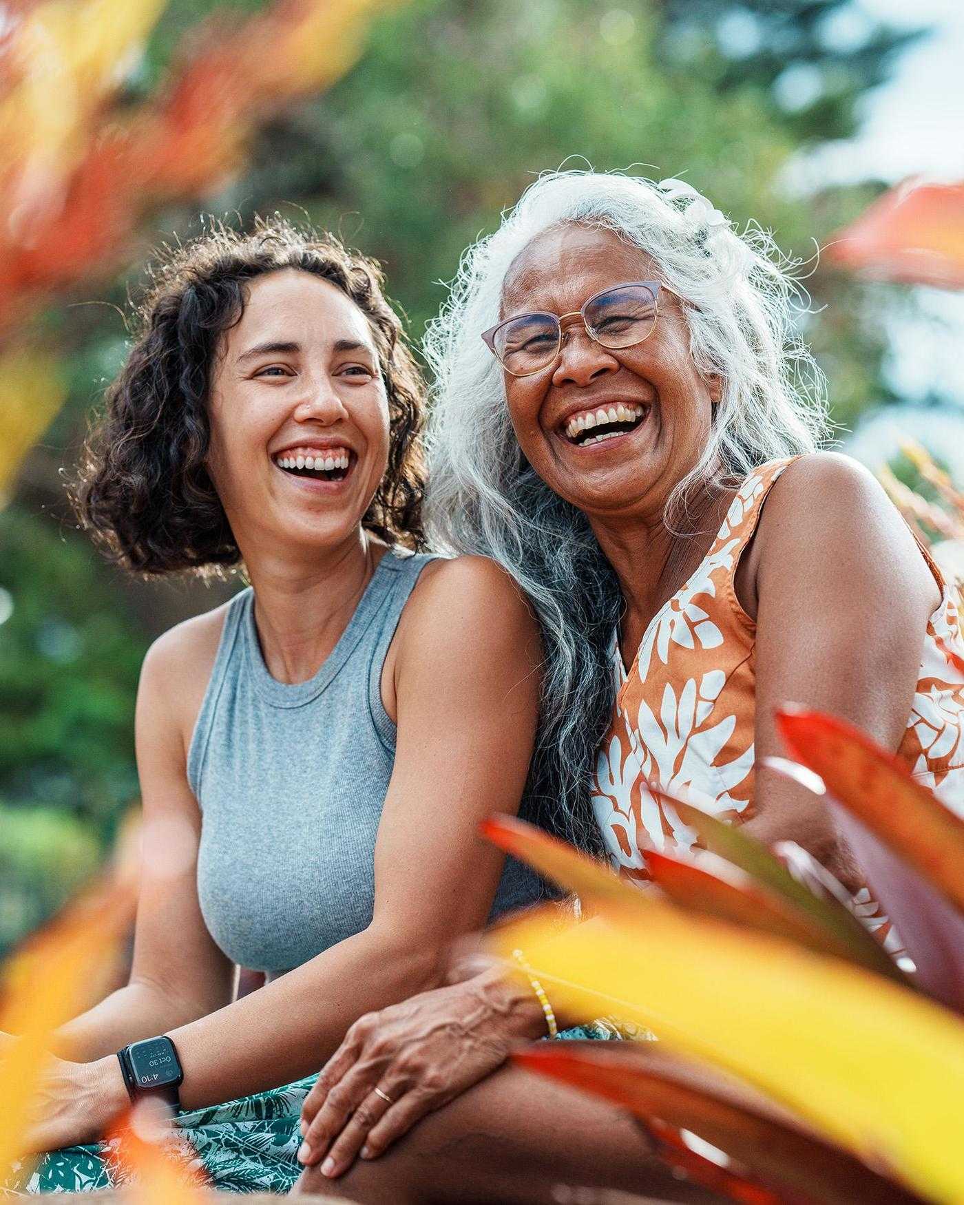 A grandmother and grandaughter smiling in the tropics