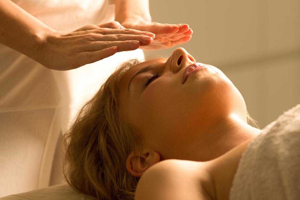 A woman getting a reiki healing