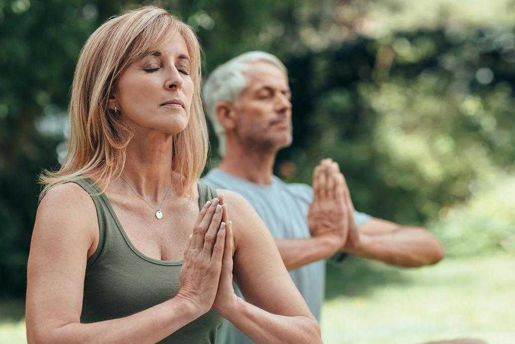 A woman meditating in the forest