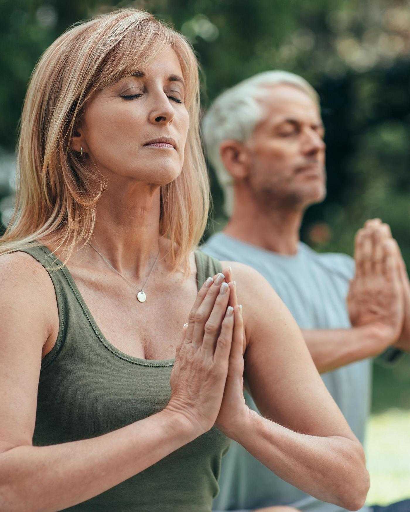 A woman meditating in the forest