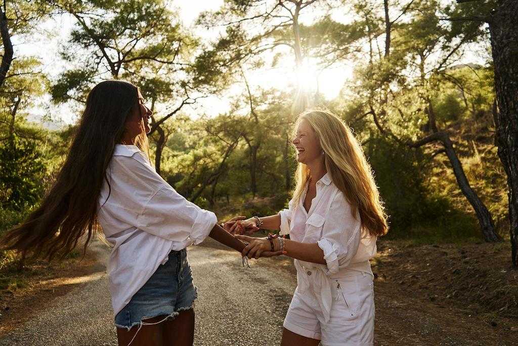 Two women dancing in the forest