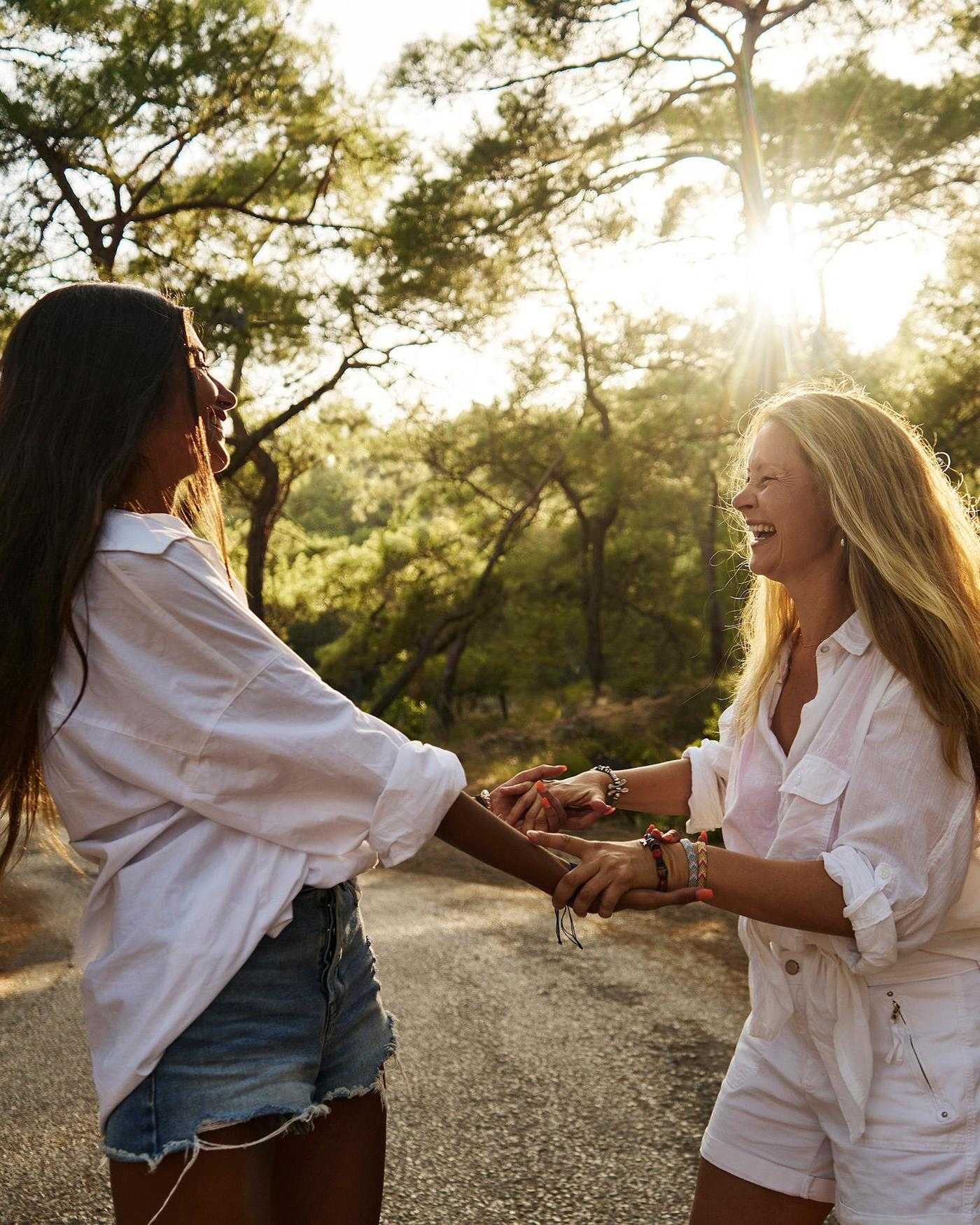 Two women dancing in the forest